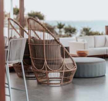 Two stylish woven chairs in a cozy outdoor setting.