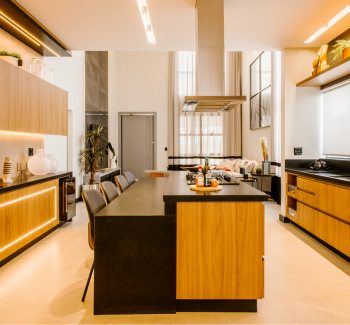 Modern kitchen furniture including a wood and black island, sleek cabinets, and a range hood.