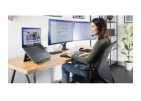 A lady working on a computer at an ergonomic table.