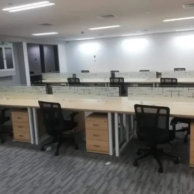 A modern, open-plan office with partitioned workstations.