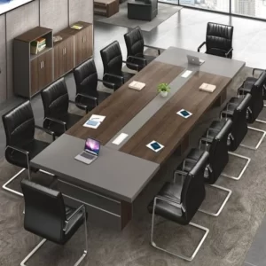 Modern conference room setup with a large wooden table and black leather chairs.