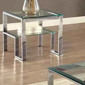 A steel furniture with glass on top along with a flower pot.