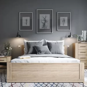 Modern bedroom furniture with a central bed and a small side table.