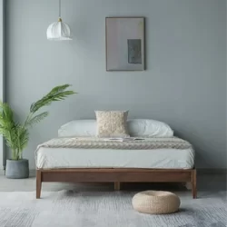 Bedroom with customized wooden bed furniture and an indoor plant.