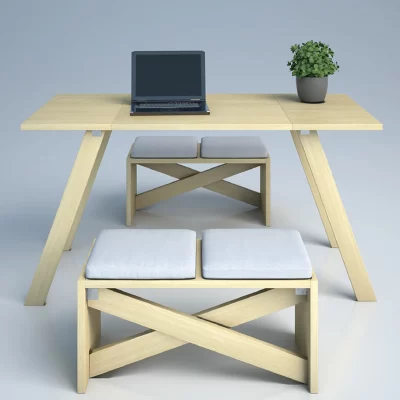 A light wood desk with a laptop and potted plant, accompanied by two cushioned benches.