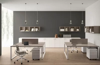 A office furniture Saudi Arabia space with two desks, a filing cabinet, and shelves.