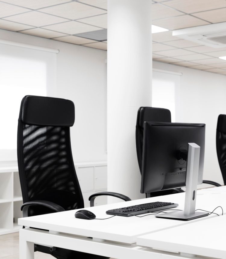 Modern office workspace with desk, chairs, and computer