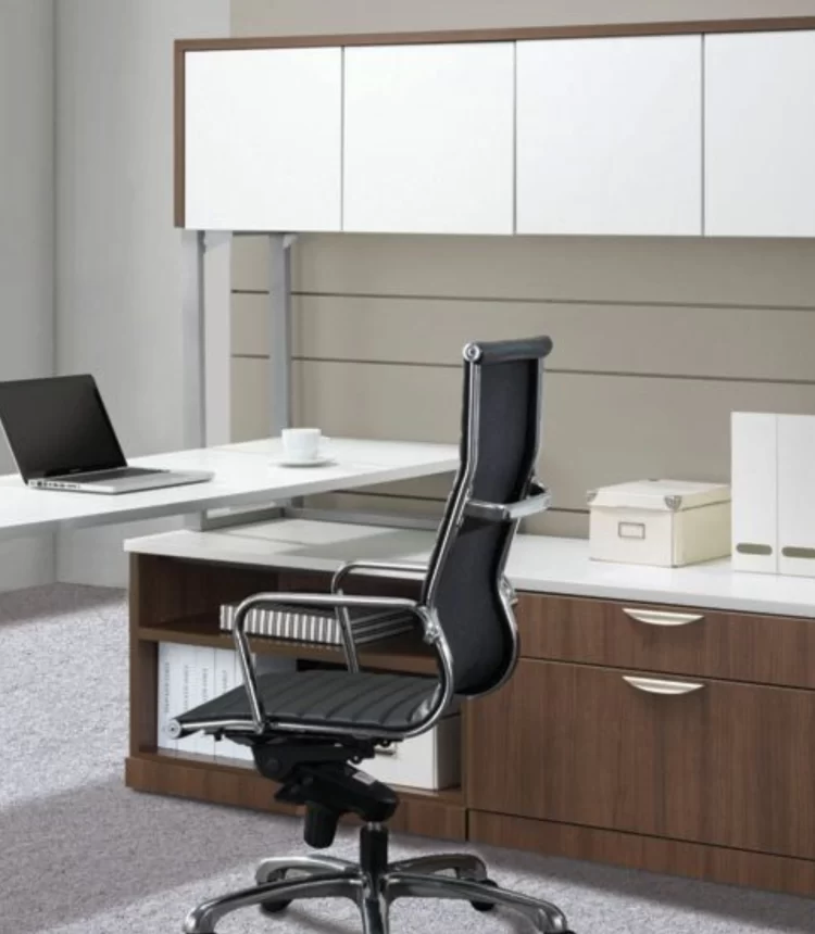 Ergonomic office chair in a modern workspace with desk and storage.