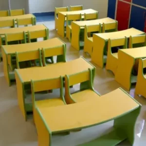 A set of educational furniture, specifically colorful desks and chairs arranged neatly in a classroom.